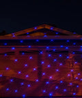 Motion Snow Fall Light Show With White Laser And 7 Color Star Effects Christmas Lights on garage door at night