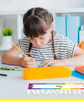 Child writing at desk with 40 Pack Waterproof Desk Name Plates With Alphabet And Number Line 1-30 Traditional Manuscript Style