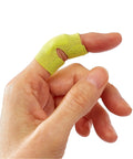 Close-up of yellow fabric strip from Extreme Hold Antibacterial Bandages For Fingers And Knuckles on thumb, flexible design