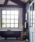 Modern bathroom with black bathtub and Freestanding Tub Filler Kit With Single Riser For Floor Joist Concrete Mounting.
