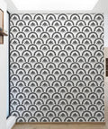 Black geometric peel and stick wallpaper seen on accent wall, 17.52inx196.85in vinyl adds modern touch.