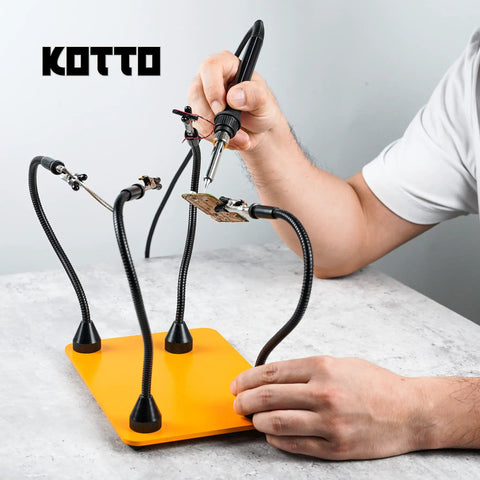 Person using Third Hand Soldering Tool With Four Magnetic Gooseneck Arms And Stainless Clips For PCB Holder Soldering Repairs Jewelry And Crafts 360 Degree Rotation Non Slip Weighted Base Handy Helping Hands Station.