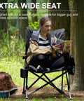 Person seated on Oversized Padded Folding Camping Chair For Adults, Heavy Duty Portable Quad Chair With Side Pockets in forest