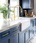 Modern kitchen with blue cabinets featuring 6 Inch T Shaped Bar Cabinet Pulls 8 Pack Stainless Steel Handles in gold finish.
