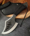 Beast Fixed Blade Axe Knife With Saw Back and Sheath, black handle, shown on cutting board, ideal for camping and survival