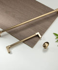 Brushed gold cabinet handles and knob displayed on wood panel, not 10 Pack Oval Ellipse Single Hole Cabinet Knobs In Champagne Bronze Zinc Alloy.