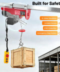 Built Like A Tank Electric Hoist Winch 220 Pound Capacity Portable Overhead Crane With Remote lifting a wooden crate.