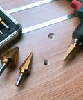 Step Drill Bit Set Unibit 5 Piece HSS Titanium Coated With Automatic Center Punch and Aluminum Case, shown with a drill on wood.