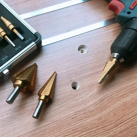 Step Drill Bit Set Unibit 5 Piece HSS Titanium Coated With Automatic Center Punch and Aluminum Case, shown with a drill on wood.