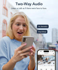 Woman using 2K Indoor Security Cam Bundle 4-Pack, viewing two-way audio feature on smartphone for pet monitoring.