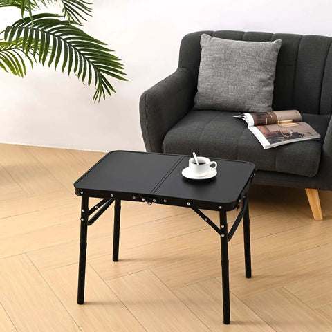 Foldable Picnic Table With Storage Net In Matte Black Aluminum Portable And Light For Camping Travel Or Indoor Use 23.6 By 15.8 Inches Three Height Settings Up To 27.5 Inches Fast Pack And Roll in indoor setting