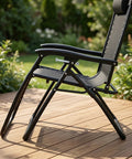 Side view of folding recliner chair with black metal frame on wooden deck, showing durable construction for wobble-free performance.