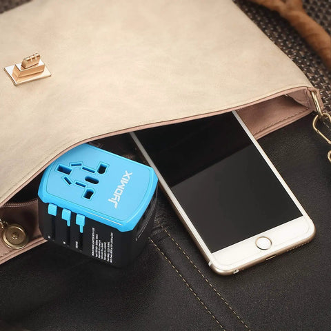 Universal USB Travel Power Adapter with Quad USB Ports and Type C for Worldwide Charging placed near smartphone in purse