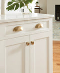 Golden Champagne Ashby Cabinet Cup Pull for 3 Inch Center To Center and 4 Inch Center To Center Spacing, installed on kitchen drawers