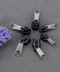 Universal Zipper Repair Kit 6Pcs Black Instant Fix Replacement Zipper Slider Teeth Pulls on gray fabric background