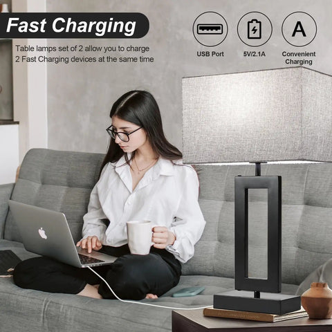 Woman sitting on couch using laptop beside 22 Inch Tall Touch Control Table Lamps With 2 USB Ports, gray fabric shade, modern design.