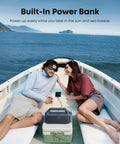 Couple in boat using Outdoor Bluetooth Speaker With Crankin Bass Subwoofer And BassUp 2.0 80W Power for camping and beach, IPX7 waterproof.