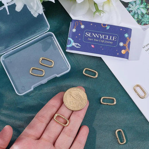 Eight Pieces Real 18K Gold Plated Brass Spring Gate Rings With Oval Clasps Carabiner Snap Hooks Keyring Buckles on table