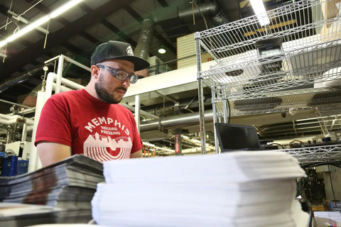 Man wearing Emerge Plus Readers Safety Glasses With Rubber Nosepiece working in a print shop.