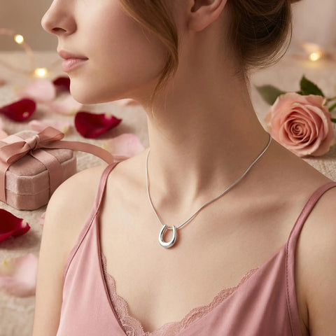 Model wearing Lucky Horseshoe Necklace For Women With U Shape Pendant In Silver Tone Stainless Steel Hypoallergenic Adjustable Chain