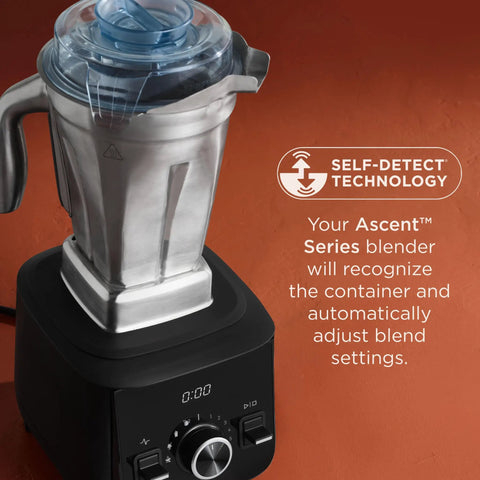 48-Ounce Stainless Steel Blender Container With Self-Detect on black blender base, clear BPA-free lid visible