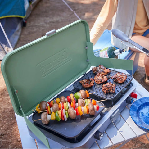 Three In One Outdoor Camp Stove With Removable Cast Iron Grill And Griddle 24,000 BTUs Portable Tailgate Ready Cooker in use outdoors