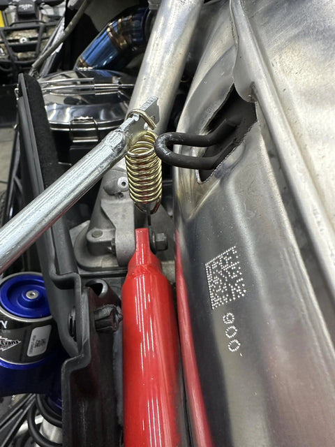 Push Industries exhaust spring removal tool with red handle and yellow coil spring, 19-inch