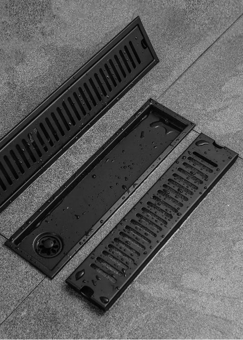 Two Pack 304 Stainless Steel Linear Floor Drain Grate With Built In Hair Catcher Heavy Duty Trench Drain Cover For Shower And Outdoor Use on wet surface.