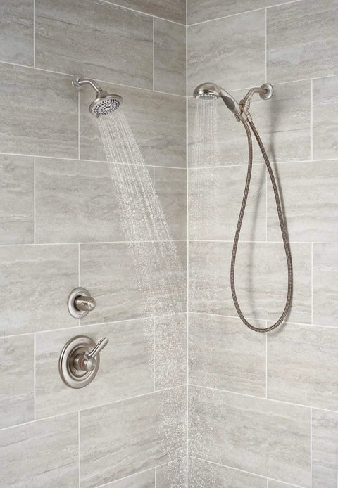 Three-Function Shower Diverter Trim Kit In Stainless Finish installed in a tiled shower with dual shower heads