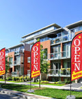 Now Open Feather Flag Pole Kit With Ground Stake Water Bag And Travel Bag Portable Outdoor Advertising Flag Banner displayed outside buildings