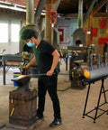 Blacksmith using a Portable Propane Forge With Triple Burners And One Side Door For Blacksmithing And Knife Making Pro Grade 2600F.