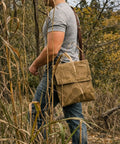 Person hiking with Waxed Canvas Haversack With Adjustable Strap for Outdoor Adventures 11 by 14 Inches Fits From Small to 5XL