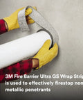 Hands applying Graphite Based Intumescent Fire Barrier Wrap Strip 2 Inch By 40 Foot Flexible Firestop around pipe.
