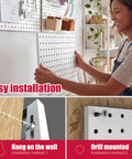 Metal Pegboard Organizer Set 4 Pack White Wall Pegboards With 50 Hooks And Baskets Built Tough For Office Craft Room Garage Sewing Room 300 Lb Capacity Rust Free No Sag Mounting System installation guide showing woman mounting pegboard.