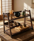 3 Tier Bamboo Matcha Station Organizer For Kitchen Countertop And Tea Bar on a wooden table, holding matcha tins, whisk, and cups.
