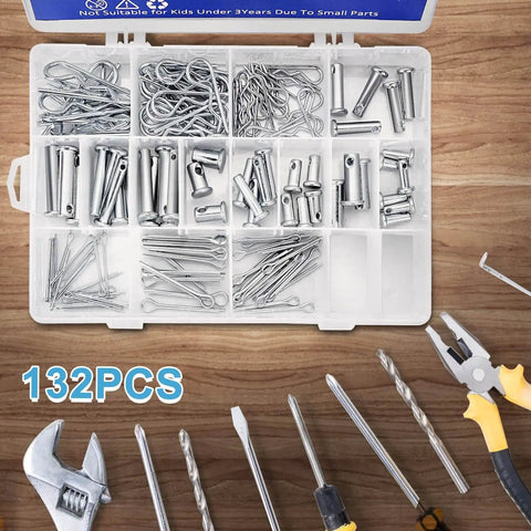 Open box containing 132 Piece Galvanized Steel Clevis Pins Set With 15 Sizes Heavy Duty Assortment Kit For Trailers Tractors Trucks Snow Plows Lawn Mowers Towing Farm Equipment Includes Cotter Pins Hair Pins, with tools on wooden surface.