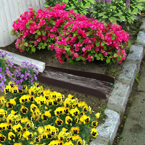 Heavy Duty Gutter Downspout Splash Blocks To Keep Your Backyard Dry And Foundation Safe 16 Inch Brown Four Pack positioned near colorful flowers.