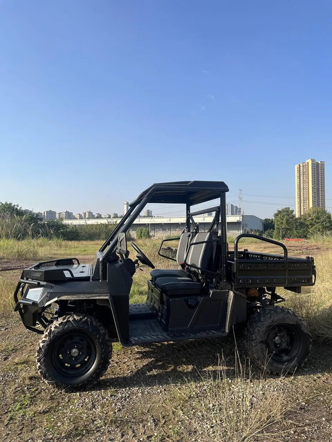 Side view of a Rugged 1000CC Utility Vehicle UTV built for heavy-duty off-road work on farms and construction sites, parked in a field.