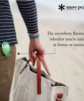Person holding a bag with Ultra Lightweight Titanium Spork For Outdoors Camping Utensil in pocket.