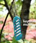 7-In-1 EDC Pocket Knife Multitool for Keychain Quick Fixes, Outdoor Gear, and Daily Tasks, Blue, hanging on tree