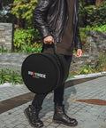 Pro Level Five Piece Drum Bag Set With Sick 10 Mm Shock Absorbing Padding, durable black case carried by a person.