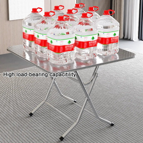 Ultra Strong Stainless Steel Folding Work Table With Thick Silicone Floor Pads And Premium Brushed Finish X Beam Reinforcement For No Sweat Garage Or Backyard Projects holding multiple water containers.
