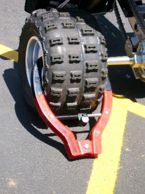 Tire Claw Security Device XL with red and black finish installed on ATV, universal fit for cars, trucks, campers, motorcycles, theft deterrent