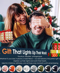 Couple exchanging gifts next to a Christmas tree, related to LED Beanie With Built-In USB Rechargeable Light For Men And Women