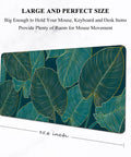 Ultra Large Green Tropical Leaves Desk Pad For Keyboard, Laptop And Computer, XXL Gaming Mouse Pad, Extra Big Full Size Mouse Mat, 35.5 By 15.7 Inches, Desk Setup Game Ready For Work And Gaming with tropical leaf design.
