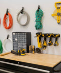Garage wall with Wall Mounted Drill Storage Rack For Four Drills Holds Up To 35 Lbs Heavy Duty Steel With Powder Coated Finish