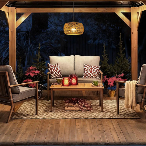 Slick Battery Operated Chandelier With Remote, 11.8 Inch Woven Rattan Cordless Pendant Light For Indoor Outdoor Patio And Porch hanging over a cozy outdoor seating area.
