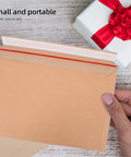 Person holding A4 Self Sealing Kraft Brown Envelopes Pack Of 30 Thickened Flat Cardboard Mailers