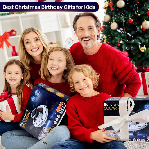 Solar Robot Science Kit For Kids Ages 8 To 14 Gift Set With Six Cool Buildable Robots That Move On Land, 120 Piece STEM Toys For Boys And Girls Teens 9 10 11 12 13, Inspiring Science Exploration And Creative Experiments. Family holding white solar robot kit boxes by Christmas tree