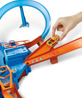 Hand placing car on Hot Wheels Criss Cross Crash Track Set With 1 To 64 Scale Car Four Intersections Motorized Booster Power Epic High Speed Crashes And Car Feeder Ramp Amazon Exclusive Toy For Kids